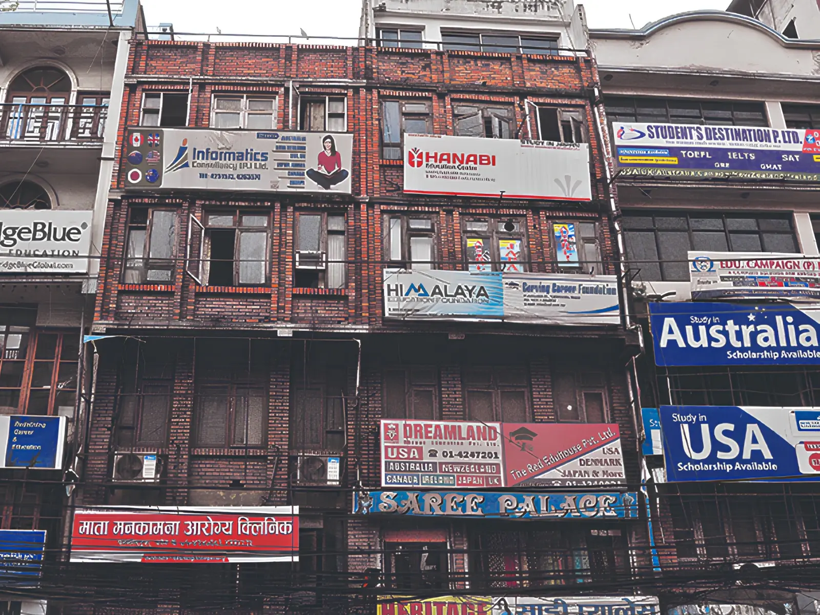 A street in Kathmandu lined with education agency signs advertising study in Australia, the USA and other destinations